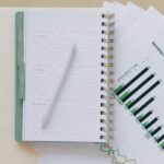 An open planner with a pen on top of graph sheets, perfect for planning and organization.